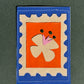 La fleur - Médaillon + Carte postale